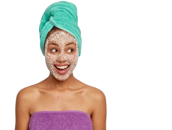 cheerful-dark-skinned-female-model-wears-towel-head-body-applies-sea-salt-mask-peeling-from-pores-looks-aside-with-satisfaction_273609-31010-Photoroom